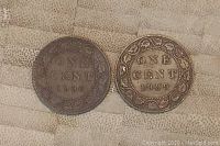 Obverse side of 1906 and 1909 Canadian large one cent coins showing text ONE CENT and respective dates surrounded by wreath design.
