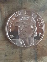 Obverse side showing detailed portrait of Donald J. Trump with a hat that reads 'POTUS 45 USA'.