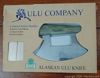 Boxed Ulu knife from Ulu Company with cultured antler handle and stainless steel blade visible through window. The box highlights the natural materials and includes a stand.