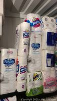 Photo showing various multipacks of Royale, Charmin toilet paper, SpongeTowels Ultra paper towels, and Majesta toilet paper on shelf.