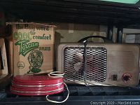 Torcan fan with original box and portable heater shown on shelf