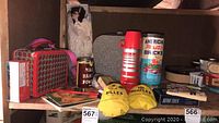 Overview of the lot showing vintage lunch boxes, thermos, Star Trek playing cards, marble bags, building bricks container, porcelain doll in box, and other collectible items.