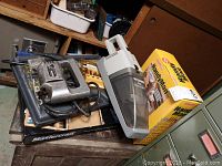 Lot contents including Ram Tool sabre saw, handheld cordless vacuum, HandyMan tool set box, and Mastercraft accessory set box.