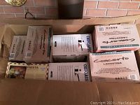 Open box showing multiple boxed saucepans including Lagostina Concerto and Meyer Chef Classic brands.