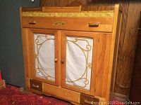 Front view of server showing waterfall veneer front, glass doors with metal grille and bottom drawer