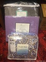 Full lot showing Dream Haven sheet set in packaging, purple mink sheet set, and gray cotton blanket.