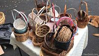 Photo showing a variety of smaller size woven baskets on a table