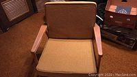 Front view of chair with cushions showing the solid gold side.