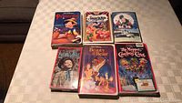 VHS tape lot of six including Disney classics and The Muppet Christmas Carol with visible front cover artwork for each.
