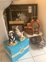 Wide view of ceramic Bambi characters (Flower and Thumper), wood boat clock, ceramic elephants, and framed pictures nearby