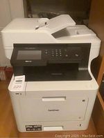 Front perspective view of the Brother MFC-L8900CDW unit with MaxSold tag attached