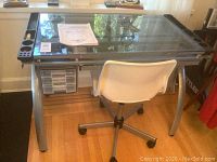 Wide shot of the glass-topped desk and white swivel chair