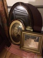 Photo of all three items: largest oval mirror, oval framed vintage portrait, and smaller rectangular mirror.