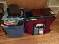 Blue plastic bin and maroon canvas tote filled with folded fabrics, wooden sewing box behind