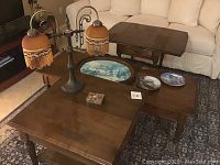 Ethan Allen wooden furniture group with coffee table, side tables, lamp, and framed painting on center table