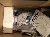 Tobi clothing steamer packed in box with instruction manual visible
