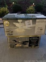 Two boxed ceiling fans, one branded Landmark Plus white finish with frosted glass lights, the other San Marino brushed steel finish with spotlight kit shown on the box sides