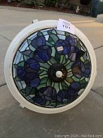 Top view of the floral stained glass mosaic ceiling light showing blue flower design and white frame.