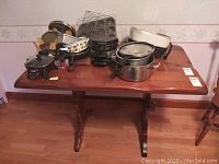 Full view of wood kitchen table with pots and kitchen items on top (items not included)