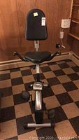 Front view of the exercise bike showing padded seat and handlebars