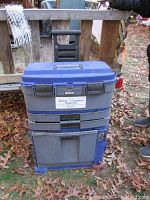 Front view of rolling tool box showing wheels, handle, drawers, and cord reel