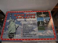 Closed game box showing colorful patriotic design with Statue of Liberty and Mount Rushmore images and list of trivia topics.