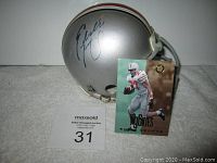 Autographed mini football helmet signed by Eddie George with the 1996 rookie card displayed in front.