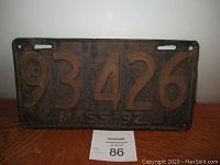 Front view of 1921 Massachusetts porcelain license plate showing embossed number 93,426 with comma and 'MASS 1921' text, displaying rust and wear.