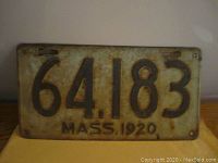 Front view of the 1920 Massachusetts porcelain license plate, number 64.183 with comma, showing rust and wear.