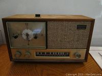 Front view of vintage Realistic AM clock radio showing clock and speaker grille along with tuning and volume controls