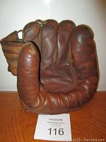 Front view of antique leather Spalding softball glove showing finger and thumb areas.