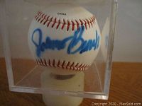 Close-up of the white Rawlings baseball showing Johnny Bench's autograph in blue sharpie ink and red stitching.
