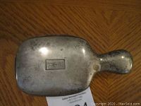 Top view showing tarnished sterling silver back with engraved initials on the hair brush.