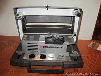 Front view of the Kodak Instamatic M80 projector with reel spindles and control knobs