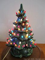 Tree lit up facing camera showing multicolored bulbs