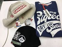 All three items together: white Hudson's Bay hat, black Space Craft beanie, blue Superdry shirt