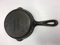 Bottom of small cast iron pan showing Javelin branding and markings including No.3 and Made in Canada