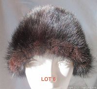 Front view of soft, shiny beaver fur hat on white mannequin head, showing full shape and texture.
