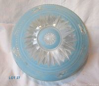Top view showing the pale blue color with embossed marine motifs and a clear glass starburst central section.