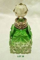 Full view of the green crystal perfume bottle with faceted clear stopper and silver-tone collar