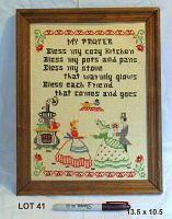 Full view of framed embroidered sampler with text, figures and decorative borders.