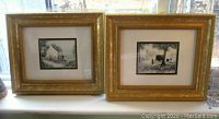 Photo showing both framed prints side by side on a windowsill, gold ornate frames, depicting Amish life scenes.