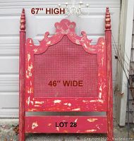 Full view of the headboard showing overall condition, detailed carved top, turned posts, and distressed paint.