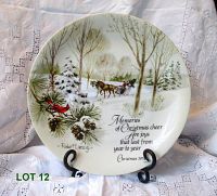 Full view of 10 inch plate showing winter scene with horse-drawn sleigh, snow-covered pine branches with pine cones, cardinal bird, and text with artist signature.