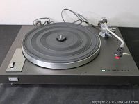 Front view of the Sansui SR-222 turntable showcasing the platter, tone arm, and power cord.