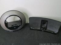 Photo showing both Klipsch iGroove HG and JBL Radial 30-pin iPod dock speaker units side by side from front.