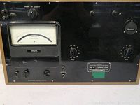 Front view of AC-DC Transfer Stand with analog voltage meter and control knobs, model FLN.