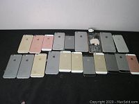 Front view showing 14 iPhone back housings and 2 front displays in gold, rose gold, silver and gray colors in varying worn condition