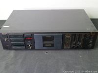 Front view of Nakamichi BX-150 cassette deck showing buttons, display, and dual meters.