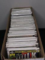 Front view of long box filled with bagged comics, showing 'The Incredible Hulk' cover